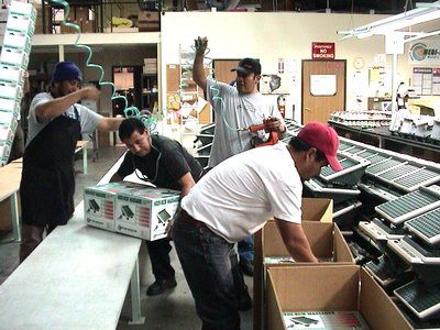 A Diverse Team Of Workers Collaborating In A Factory